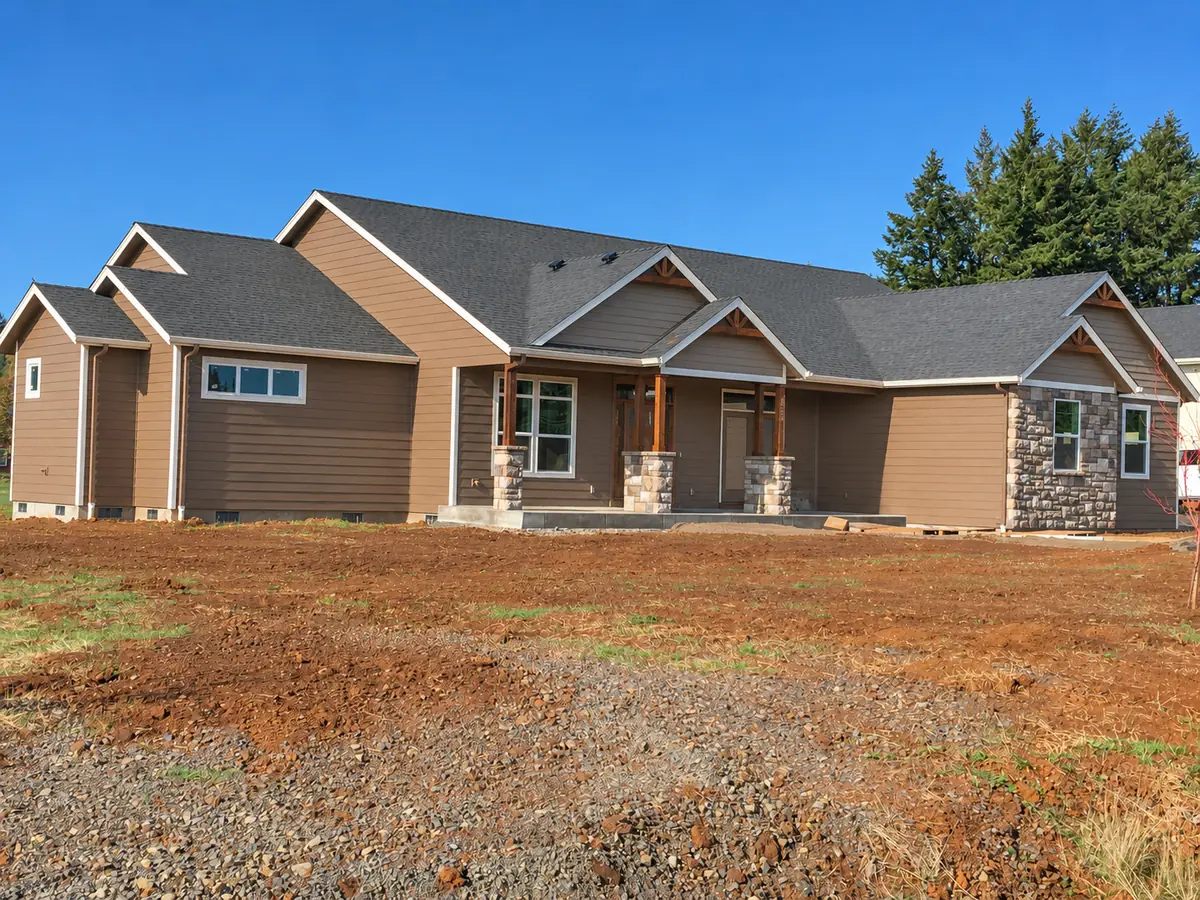 Long single-story craftsman with stone wainscot and gable dormers